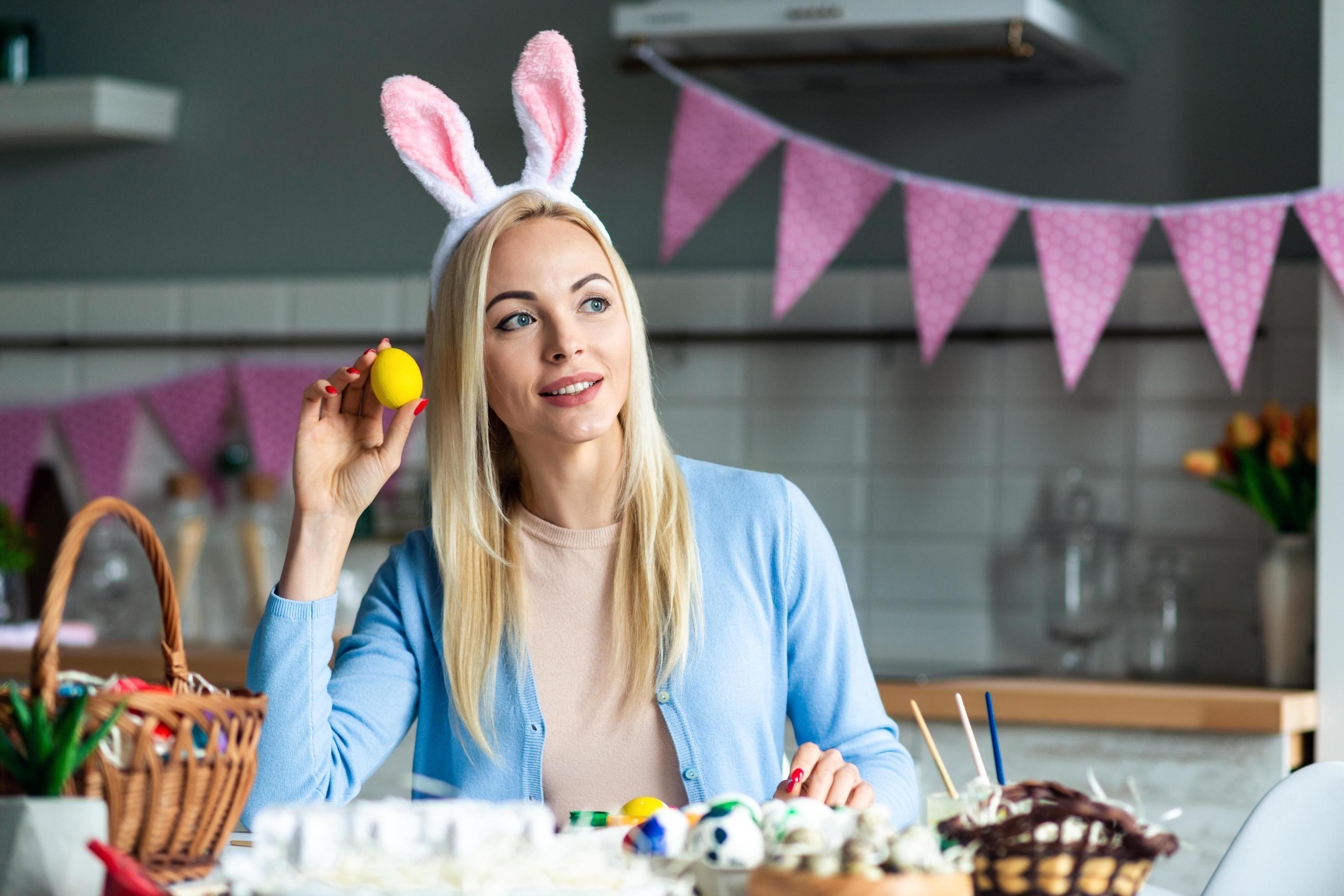 beautiful-blond-woman-holds-an-easter-egg-in-her-hand-and-looks-away-dreamily-free-photo.JPG
